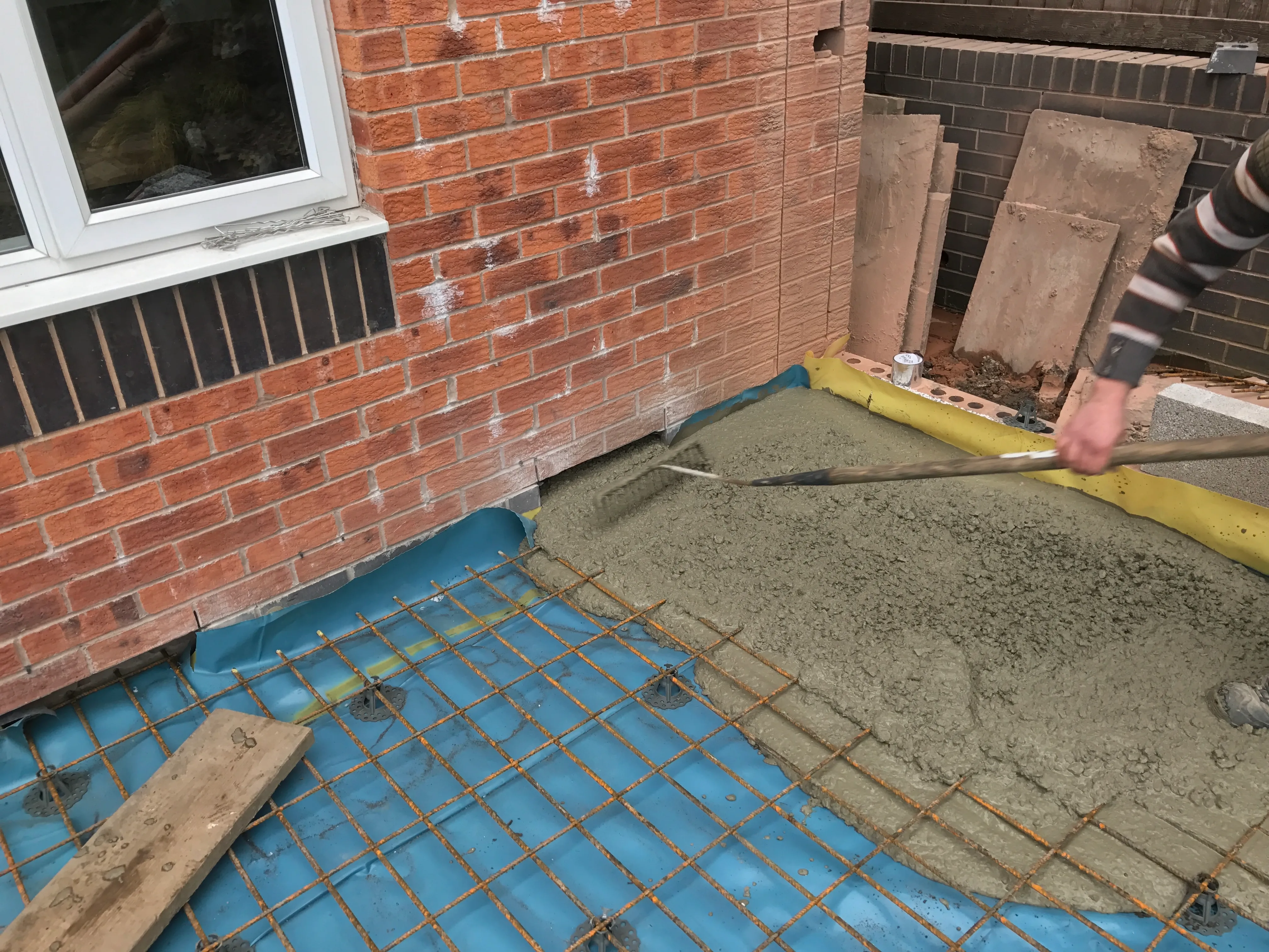 Foundations and slab: Reinforced concrete slab poured for a rear extension.