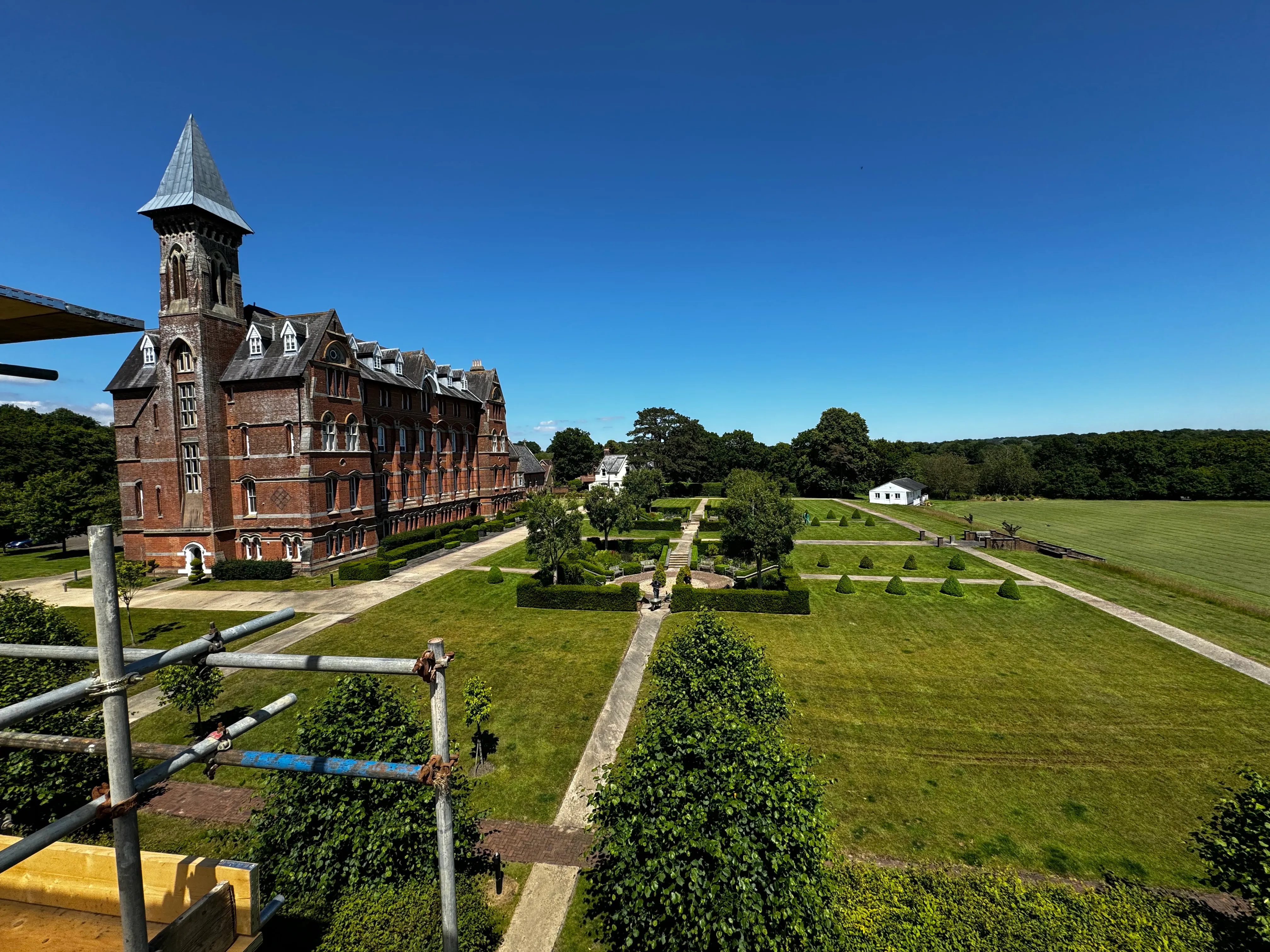 Aerial view of a large Victorian building and formal gardens during reinstatement works