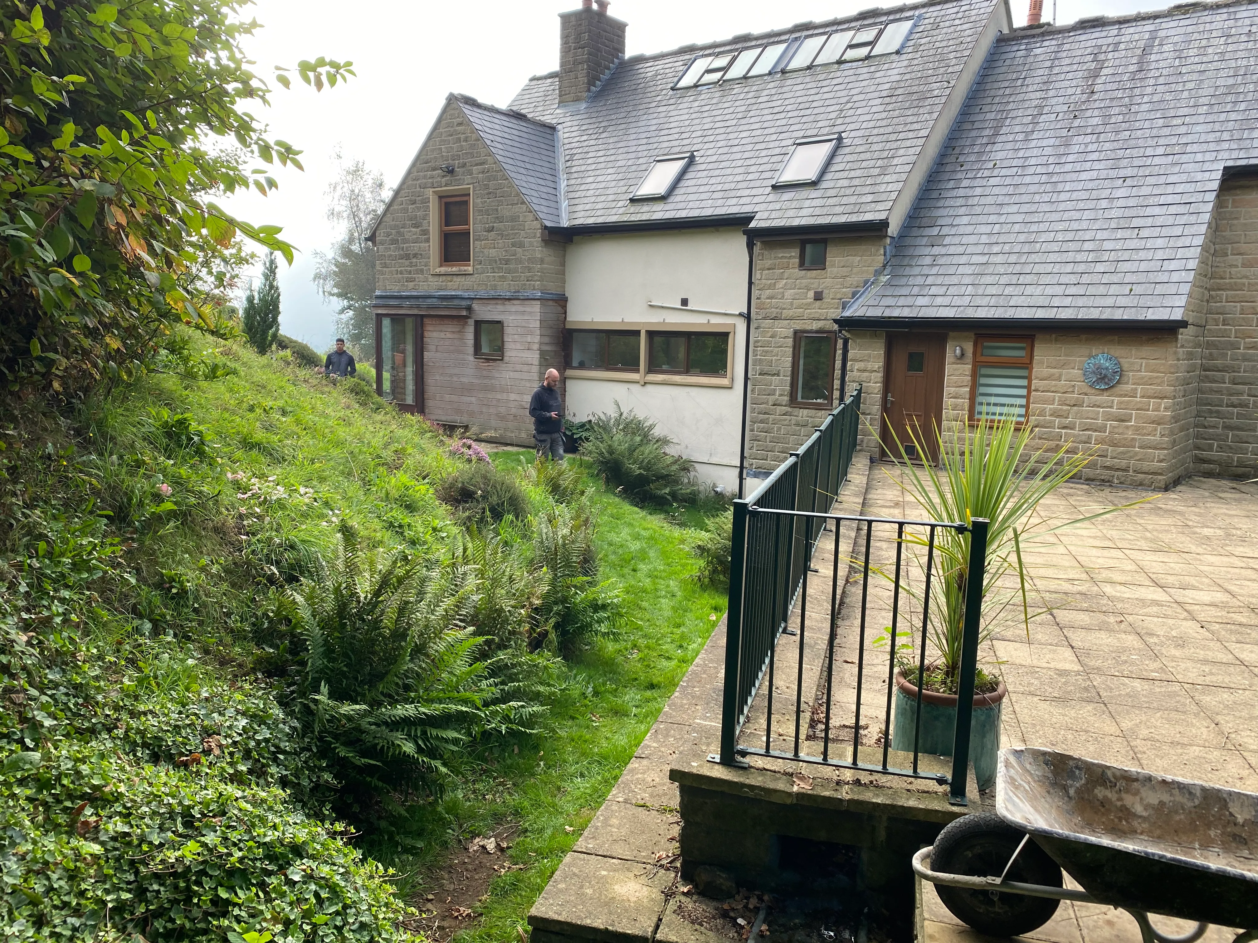 The existing stone property before the transformation, garden and patio view