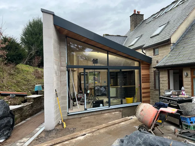 Extension exterior with cladding in progress