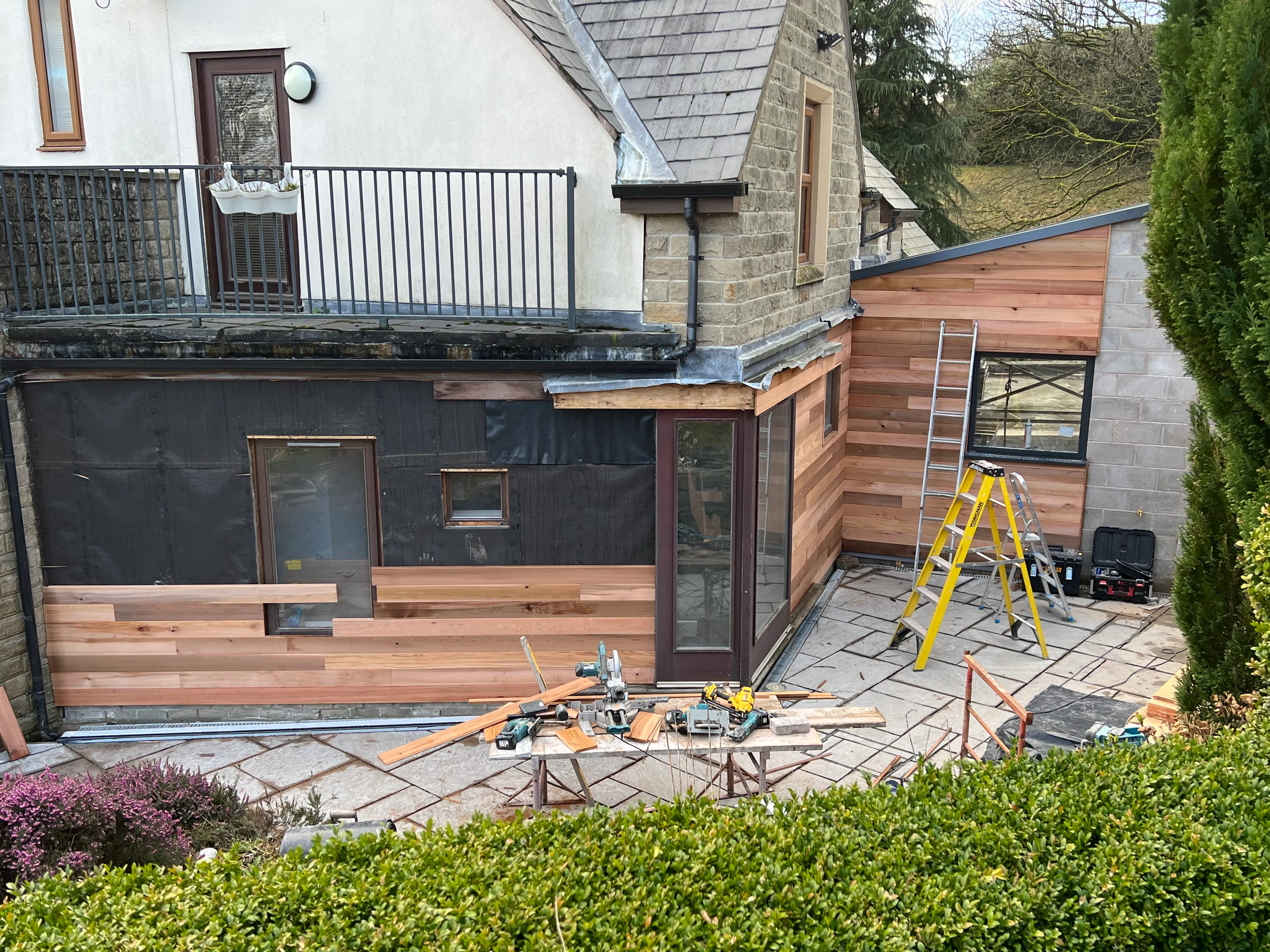 Cedar cladding being installed on the extension exterior
