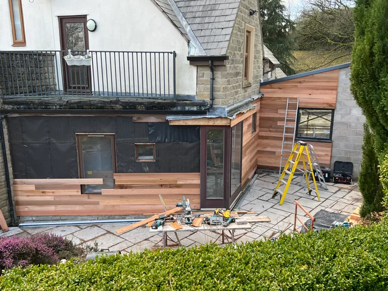 Cedar cladding being installed on the extension exterior